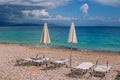 View of empty beach Ã¢â¬â white deck chairs and umbrellas near sea water Royalty Free Stock Photo